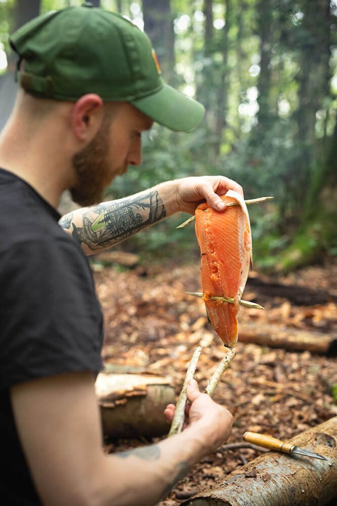 Outdoorsman Padraig Croke cooking fish outdoors for Another Escape Belonging Volume