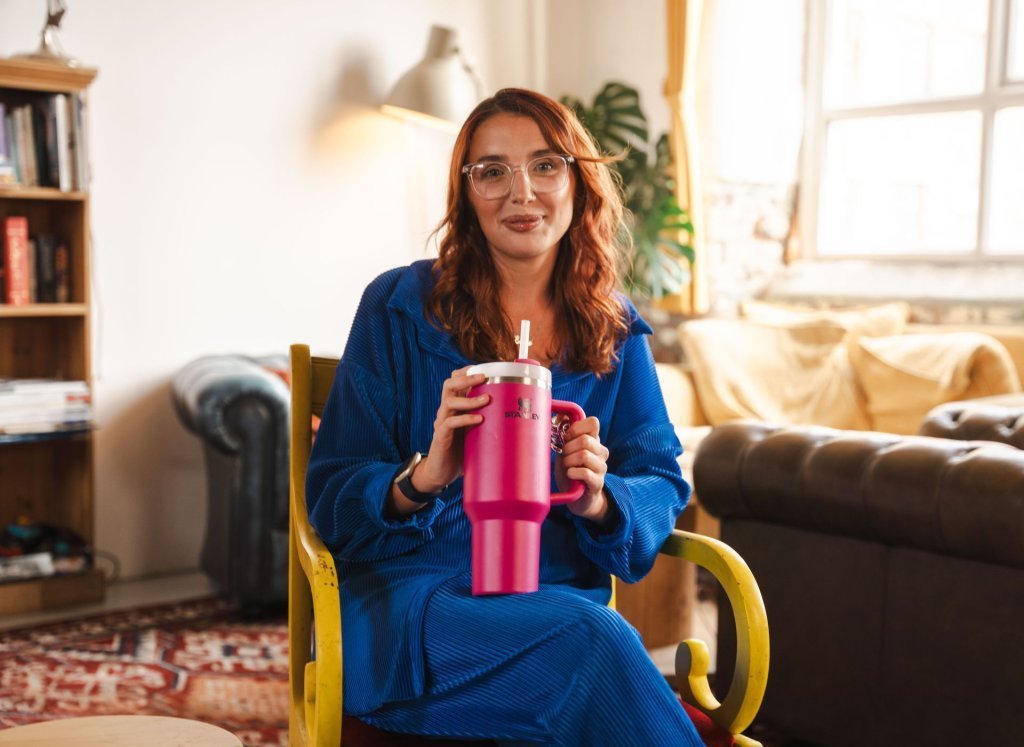 Ellie Middleton sitting with a pink Stanley Quencher
