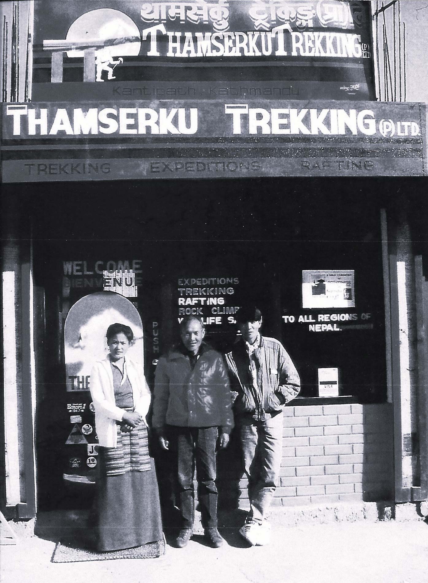 Pasang and her husband Sonam pose in front of their business, Thamserku Trekking
