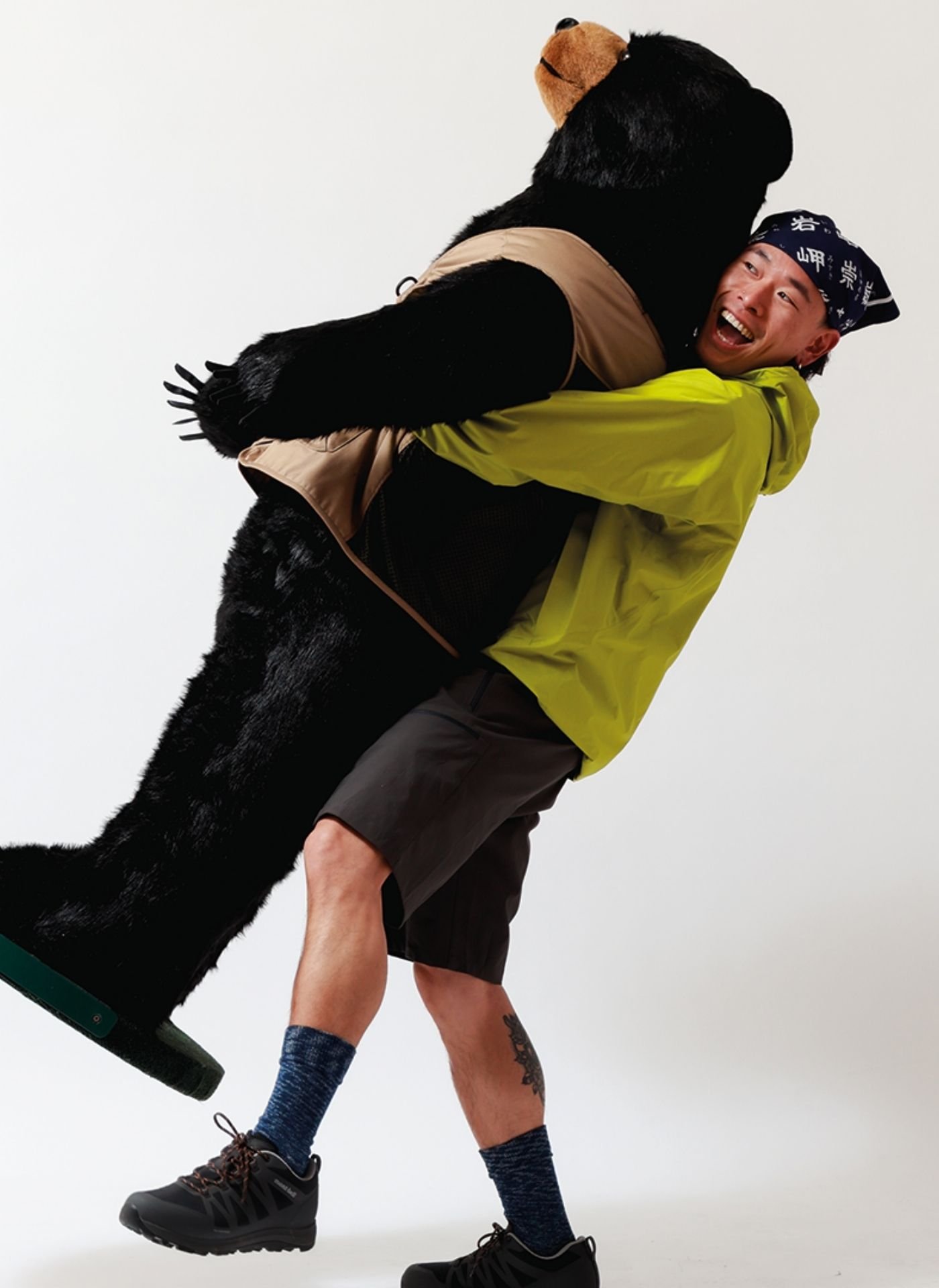 Model in studio lifting Montbell bear